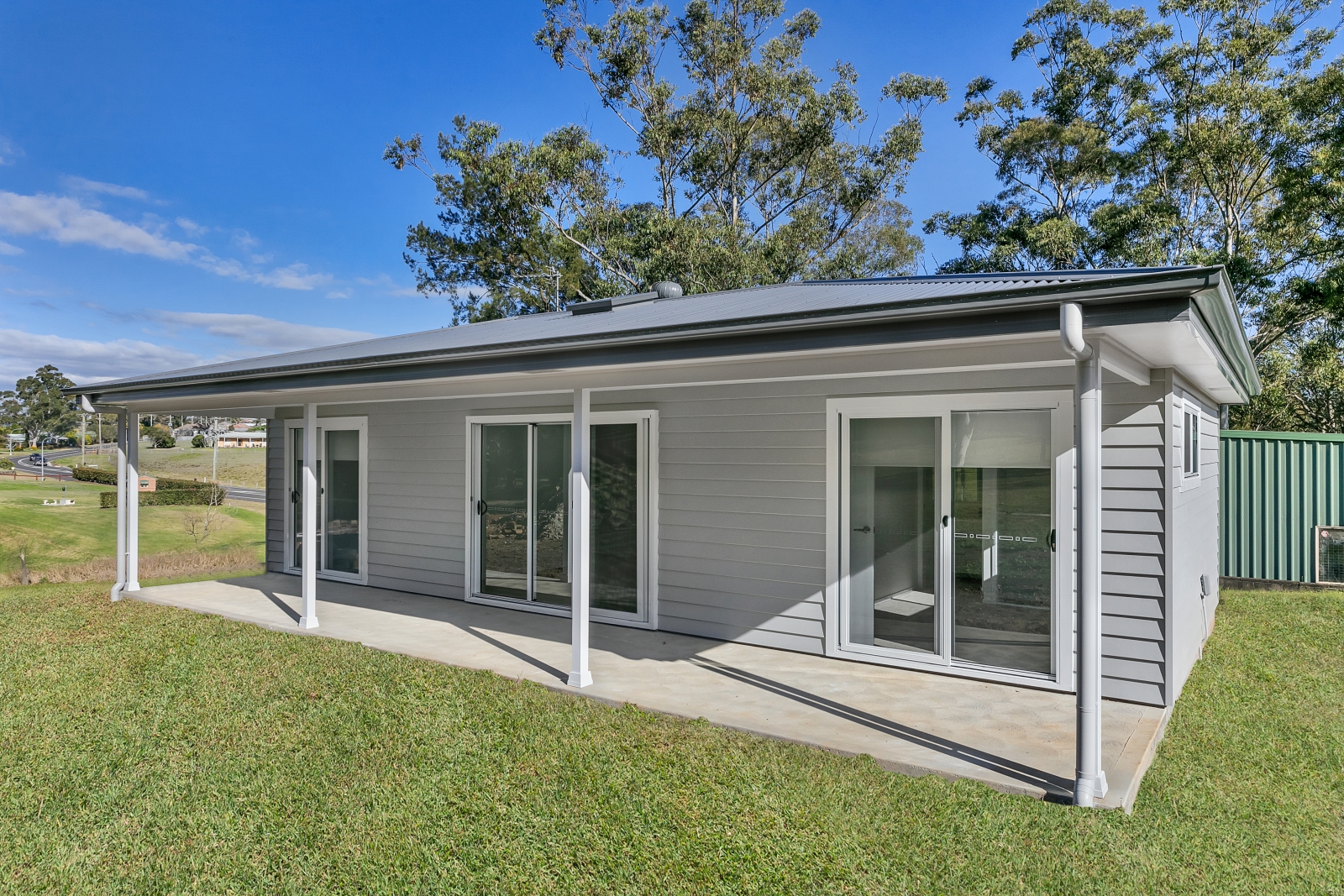 Rear view of a granny flat in Largs with full length covered alfresco and sliding doors by P J Cook Building