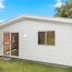 Rear exterior view of a Tuggerah granny flat with sliding door access to the backyard